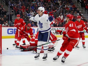 Nick Shore of the Maple Leafs celebrates his first-period goal in front of Red Wings forward Luke Glendening last night at Little Caesars Arena in Detroit. It was Shore’s first NHL goal since April 2018.  Gregory Shamus/Getty Images