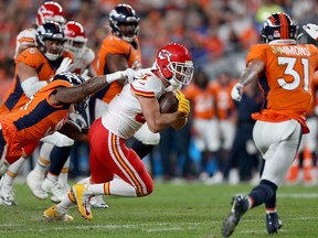 Travis Kelce of the Kansas City Chiefs is tackled by the defense of the Denver Broncos  in the game at Broncos Stadium at Mile High on October 17, 2019 in Denver, Colorado. (Matthew Stockman/Getty Images)