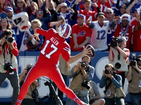 Josh Allen of the Buffalo Bills throws the ball into the crowd after scoring a two point conversion during the fourth quarter of an NFL game against the Miami Dolphins at New Era Field on October 20, 2019 in Orchard Park, New York.