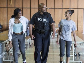 In this Toronto Sun file photo, which was taken on June 12, 2017, Toronto Police Const. Alphonso Carter walked the halls of Cardinal Newman High School greeting and talking with students. Carter worked as a school resource officer at the high school until the Toronto District School Board scrapped the program. (Craig Robertson, Toronto Sun)