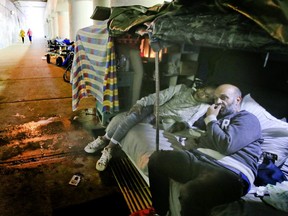 Neil and Camille live in a makeshift tent underneath a bridge on lower Simcoe St on  Oct. 2, 2019. (Veronica Henri/Toronto Sun)