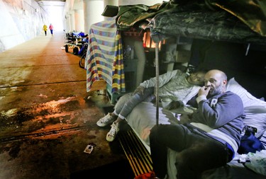 Neil and Camille live in a makeshift tent underneath a bridge on lower Simcoe St on  Oct. 2, 2019. (Veronica Henri/Toronto Sun)