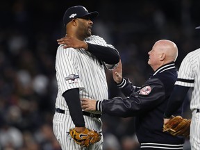 New York Yankees pitcher 
CC Sabathia is examined by trainer Steve Donohue after suffering a shoulder injury during Game 4 on Thursday night against Houston. (USA TODAY SPORTS)