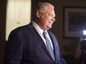 Ontario Premier Doug Ford makes his way to a press scrum September 17, 2018.  THE CANADIAN PRESS/Chris Young