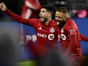 Toronto FC midfielder Nick DeLeon (18) celebrates his goal with teammate Alejandro Pozuelo (10) during extra time MLS playoff soccer action against the D.C. United, in Toronto on Saturday, Oct. 19, 2019. (FRANK GUNN/THE CANADIAN PRESS)