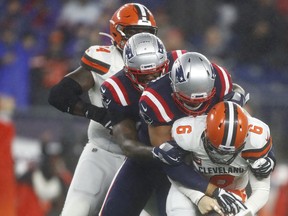 Browns quarterback Baker Mayfield is sacked by Patriots' Kyle Van Noy on Sunday. (GETTY IMAGES)