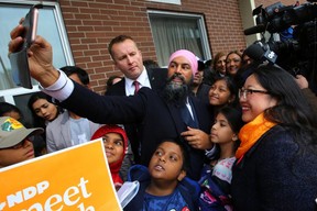 Canada’s New Democratic Party (NDP) leader Jagmeet Singh, accompanied by Beaches-East York candidate Mae J. Nam, takes a selfie with kids during an election campaign visit stop at Crescent Town Elementary School in Toronto, Ontario, Canada October 17, 2019.