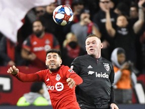 Toronto FC forward Alejandro Pozuelo (left) and DC United forward Wayne Rooney fight for the ball at BMO Field on Saturday.  Gerry Angus/USA TODAY Sports