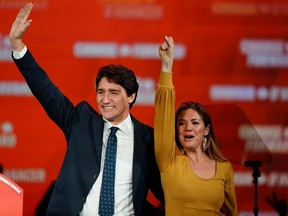 Liberal Leader and Canadian Prime Minister Justin Trudeau and his wife, Sophie Gregoire Trudeau, wave to supporters after the federal election at the Palais des Congres in Montreal October 22, 2019. REUTERS/Carlo Allegri