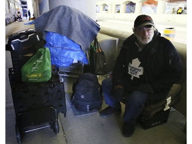 A homeless man living on Lower Simcoe Street in Toronto on Friday, October 4,  2019. "Mitch" packs up his belongings and waits for city workers to ask him to clear out. He has been evicted seven times, but always returns to the same spot. Veronica Henri/Toronto Sun/Postmedia Network