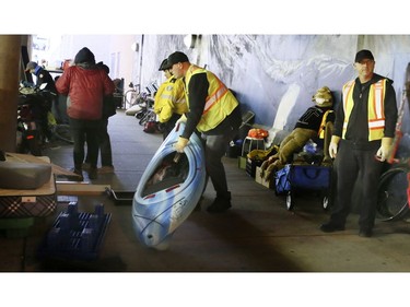 City workers remove a kayak that a homeless man has stored with his other belongings on Lower Simcoe Street in Toronto on Friday, October 4, 2019. Veronica Henri/Toronto Sun/Postmedia Network