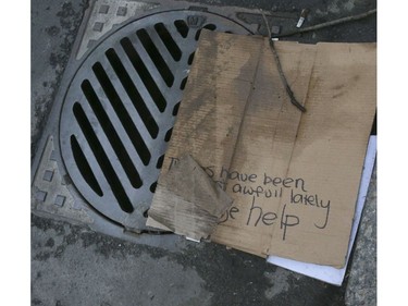 A grate have fills a sign left my a homeless person looks for donations in Toronto on Friday, October 4, 2019. Veronica Henri/Toronto Sun/Postmedia Network