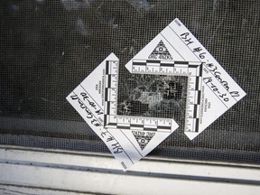 Police markers on the window of a residence that was sprayed with bullets early Wednesday, Oct. 30, 2019 on Conron Place in Toronto. (Craig Robertson/Toronto Sun)