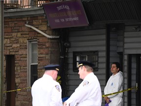 New York police officers secure a crime scene outside a club after a shooting in Brooklyn on Oct. 12, 2019. (JOHANNES EISELE/AFP via Getty Images)