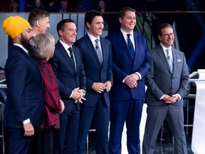In this photo taken on October 10, 201, federal party leaders (from left) NDP leader Jagmeet Singh, Green Party leader Elizabeth May, People's Party of Canada leader Maxime Bernier, host Patrice Roy from Radio, Canada's Prime Minister and Liberal leader Justin Trudeau, Conservative leader Andrew Scheer, and Bloc Quebecois leader Yves-Francois Blanchet pose for pictures before the Federal leaders French language debate at the Canadian Museum of History in Gatineau, Quebec.(ADRIAN WYLD/POOL/AFP via Getty Images)