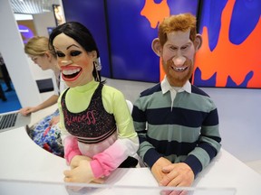 Puppets depicting the Duke and Duchess of Sussex, Prince Harry and his wife Meghan, are seen at the stand of British satirical television puppet show " Spitting Image " during the MIPCOM, the World's biggest television and entertainment market, on October 14, 2019 in Cannes, southeastern France. (Photo by VALERY HACHE / AFP)