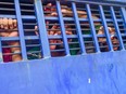 A suspect inside a vehicle reacts following a verdict that sentenced 16 people to death over the murder of a 19-year-old female student, in Feni on October 24, 2019.