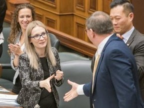 Kitchener South-Hespeler MPP Amy Fee offers a congratulatory handshake to Peterborough—Kawartha MPP Dave Smith after Bill 46 passes second reading at Queen's Park in Toronto, Ont. on Thursday, Nov. 15 2018. (Bryan Passifiume/Toronto Sun)