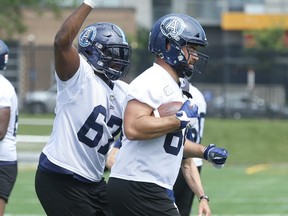 Argos offensive lineman Ryan Bomben lugs the pigskin during one of the team’s drills that features him as a tight end. Bomben, who recently played in his 150th CFL game, has three career touchdowns while lining up as a tight end.  Jack Boland/Toronto Sun