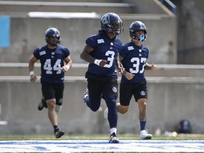 Joining DB Alden DarbyJr. (middle) in this sprint drill during an Argos practice are linebacker Ian Wild (left), who moves into the middle for tonight’s game against the Lions, and cornerback Anthony Covington (right), who returns from the injury list to start.  Jack Boland/Toronto Sun