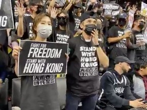 Pro-democracy protesters supporting Hong Kong are seen on the stands of Barclays Center during a game between the Brooklyn Nets and Toronto Raptors, in New York City, New York, U.S., October 18, 2019 in this still image obtained from social media video.