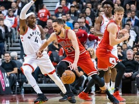 Chicago Bulls guard Tomas Satoransky moves the ball against Toronto Raptors forward Rondae Hollis-Jefferson during the first half at Scotiabank Arena.