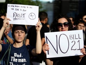 People protest Quebec's new Bill 21, which will ban teachers, police, government lawyers and others in positions of authority from wearing religious symbols such as Muslim head coverings and Sikh turbans, in Montreal, on June 17, 2019.