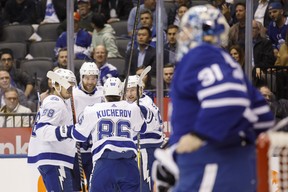 Nikita Kucherov of the Tampa Bay Lightning celebrates his goal with teammates Mikhail Sergachev (left), Victor Hedman (second from left) and Steven Stamkos as Maple Leafs goaltender Frederik Andersen looks on during the first period on Thursday night in Toronto. Tampa’s top line combined to record 11 points in the lopsided victory. (Cole Burston/The Canadian Press)