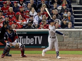 Alex Bregman of the Houston Astros hits a grand slam home run against the Washington Nationals during the seventh inning in Game Four of the 2019 World Series at Nationals Park on Oct. 26, 2019 in Washington, D.C.