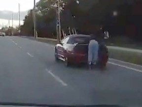 Halton Regional Police are searching for the driver of a vehicle who allowed a passenger to cruise on its back bumper. (Halton Regional Police/Twitter)