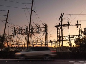 A car drives past a power station in Mill Valley, Calif., as a statewide blackout continues on Thursday, Oct. 10, 2019.