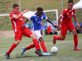 Michael Salhi (No. 3) and William Boyer (5) of Canada challenge a French player (middle) at the Danone Nations Cup at the Salou Soccer Sporting Complex in Salou, Spain on Thursday, Oct. 10, 2019. Canada lost 4-1.