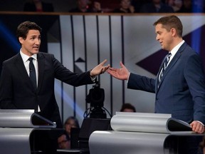 Conservative leader Andrew Scheer (R) and Canadian Prime Minister and Liberal leader Justin Trudeau gesture to each other during the Oct. 7, 2019 leaders debate. (Photo by JUSTIN TANG/POOL/AFP via Getty Images)
