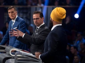 People’s Party of Canada Leader Maxime Bernier (L) and NDP Leader Jagmeet Singh (R) look on as Bloc Quebecois Leader Yves-Francois Blanchet speaks during the Oct. 7, 2019 leaders debate. (Photo by JUSTIN TANG/POOL/AFP via Getty Images)
