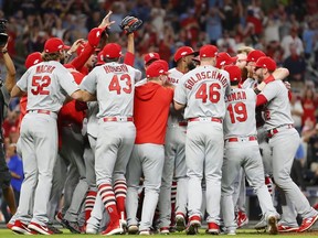 The St. Louis Cardinals celebrate their 13-1 win over the Atlanta Braves in Game 5 of the National League Division Series at SunTrust Park in Atlanta, on Wednesday, Oct. 9, 2019.