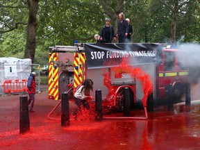 Extinction Rebellion protestors demonstrate outside the Treasury building in London, Britain on Oct. 3, 2019. (REUTERS/Simon Dawson)