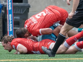 Wolfpack’s Ashton Sims (bottom) and Chase Stanley combine to take down Ashton Golding of the Featherstone Rovers during their July match at Lamport Stadium. The two teams meet again today in the final at Lamport.                                MATHEW TSANG/PHOTO