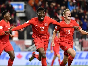 Team Canada’s Alphonso Davies (left) and Liam Fraser celebrate Davies’ goal against the Americans in the 63rd minute of Tuesday night’s CONCACAF Nations League match at BMO Field. (Martin Bazyl/Canada Soccer)