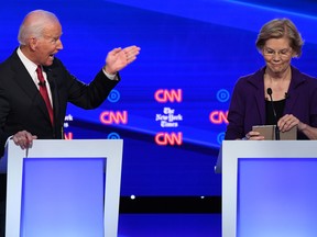 In this file photo taken on Oct. 15, 2019, Democratic presidential hopefuls Joe Biden speaks as Elizabeth Warren, right, listens during the fourth Democratic primary debate of the 2020 presidential campaign season at Otterbein University in Westerville, Ohio. (SAUL LOEB/AFP via Getty Images)