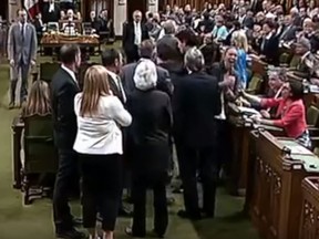 MP Ruth Ellen Brosseau grabs her chest after being elbowed by Justin Trudeau in a House of Commons fracas. (Screengrab)