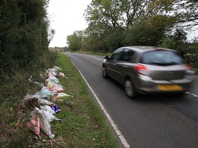 In this file photo taken on October 10, 2019, floral tributes lay on the roadside near RAF Croughton in Northamptonshire, at the spot where British motorcyclist Harry Dunn was killed on August 27. ( LINDSEY PARNABY/AFP via Getty Images)
