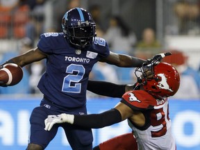 CP-Web.  Toronto Argonauts running back Chris Rainey (2) stiff arms Calgary Stampeders defensive lineman Da'Sean Downey (94) during first half of CFL action in Toronto, Friday, Sept. 20, 2019. THE CANADIAN PRESS/Cole Burston ORG XMIT: CLB105