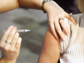 A person gets a shot during a flu vaccine program. (THE CANADIAN PRESS/Jeff McIntosh)