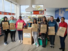 A team of Mississauga Food Bank volunteers, including Angela Adediran (third from left), gather donations at a Loblaws location. (supplied photo)