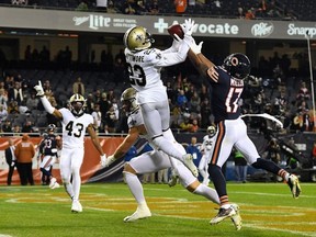 New Orleans Saints cornerback Marshon Lattimore and Chicago Bears wide receiver Anthony Miller attempt to make a play on the ball during the second half at Soldier Field.