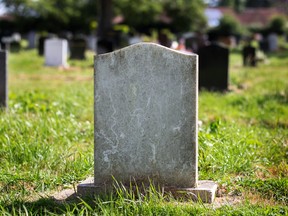 Blank gravestone with other graves in the background