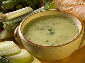leek soup decorated with fresh vegetables and bread