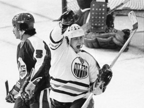 Edmonton Oilers legend Wayne Gretzky celebrates a goal while Winnipeg Jets defenceman Craig Norwich can only look on during a 1980 NHL game. Both the Oilers and Jets had been in the WHA before joining the NHL earlier that year.  POSTMEDIA NETWORK FILE