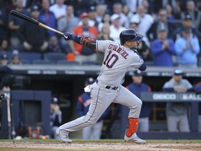 Houston Astros first baseman Yuli Gurriel hits an infield singleagainst the New York Yankees during the first inning of Game 3 of the ALCS on Tuesday. (Brad Penner/USA TODAY Sports)