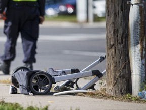 A small shoe is seen by a stroller as Toronto Police investigate the scene of hit-and-run at Pharmacy Ave. and Ellesmere Rd. in Toronto, Ont. on Sunday October 13, 2019. A 20-month-old boy in a stroller and two women were seriously injured.